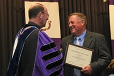 From right, Rev. Scott R. Pilarz, S.J., president of The University of Scranton , congratulates Michael A. Hardisky, Ph.D., professor of biology, in being selected as Teacher of the Year by Scranton’s Class of 2011.